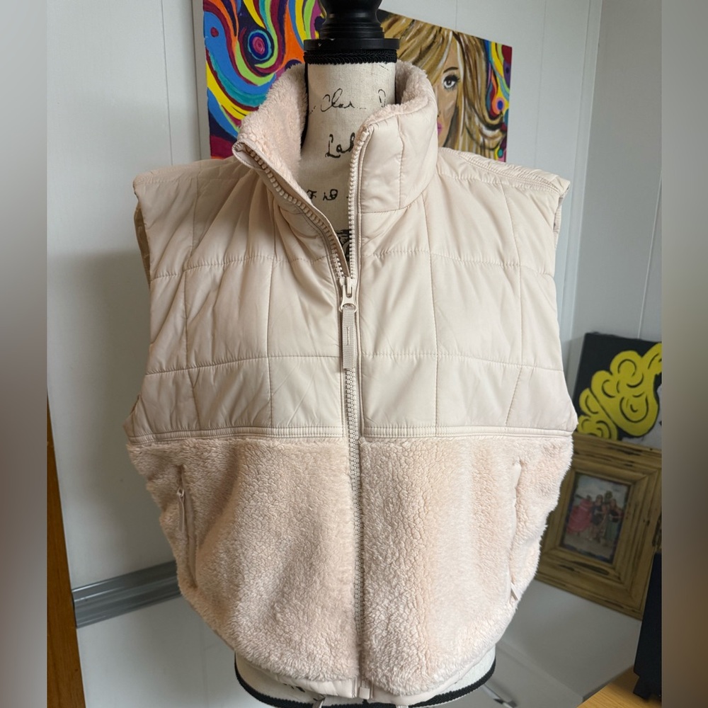 Never worn. High like and quilted vest.